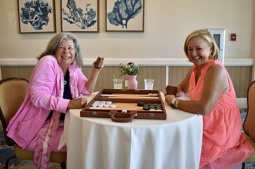 Marcie McGovern and Becky Smothers play backgammon.