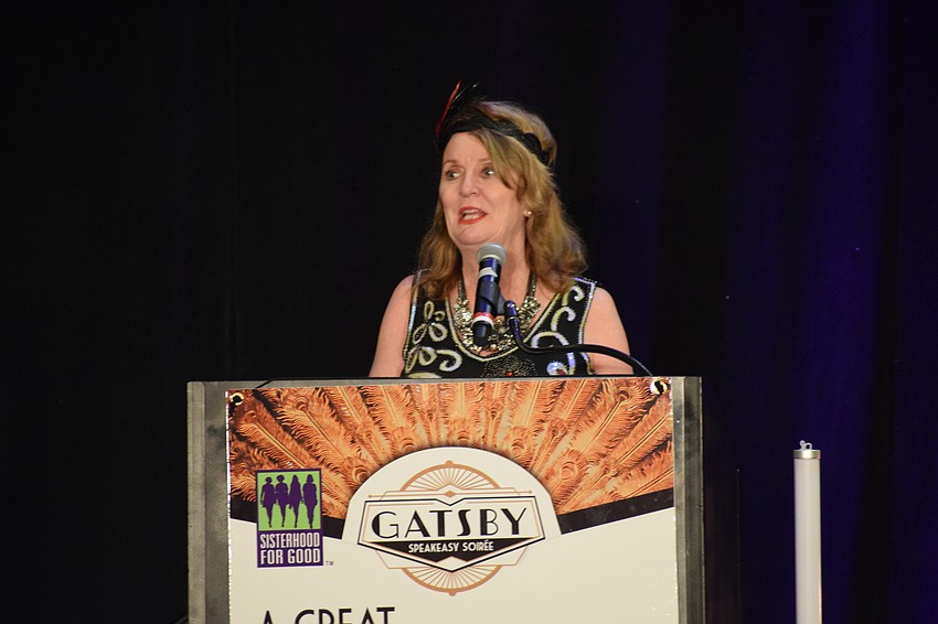 Sisterhood for Good's Amy Gorman welcomes guests to the Gatsby Speakeasy Soirée.