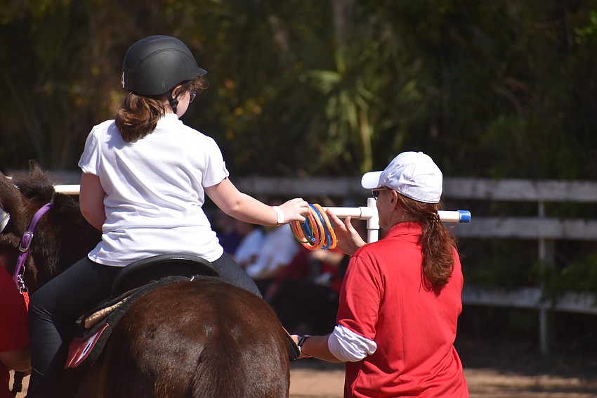 Bradenton's 11-year-old Payton Stape navigates the course alongside volunteer Melissa Newton.