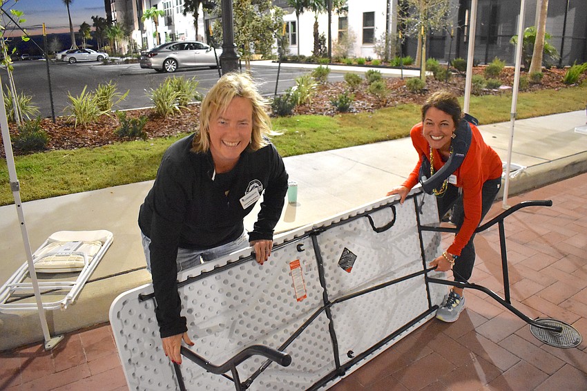 Lakewood Ranch Community Fund Executive Director Adrienne Bookhamer and Board Chair Nicole Ryskamp set up for the Run for the Beads at 7 a.m. on a chilly Saturday morning.