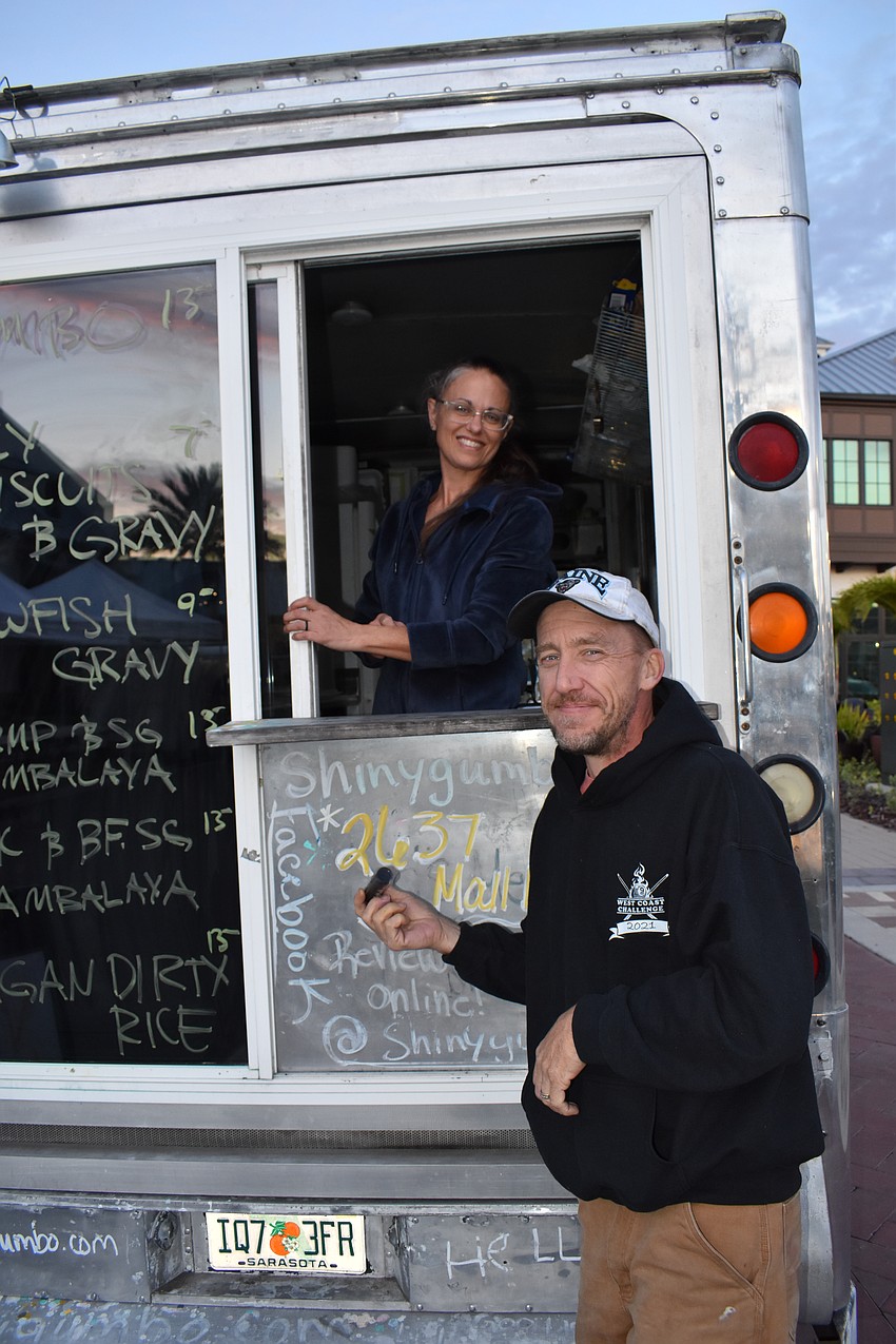 Leigh and Patrick Spencer of the Shiny Gumbo restaurant in Sarasota provide several New Orleans food favorites with their food truck at the Run for the Beads 5K at Waterside Place.