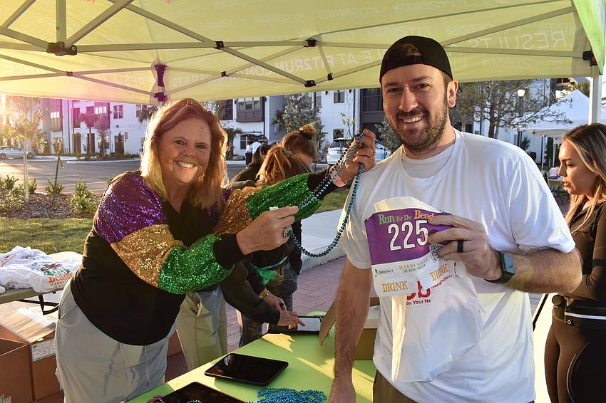 Run for the Beads Chair Annemarie Neubecker signs up Lakewood Ranch's Tommy Hargrove before the event. Hargrove says he loves to participate in 5Ks because it is a 