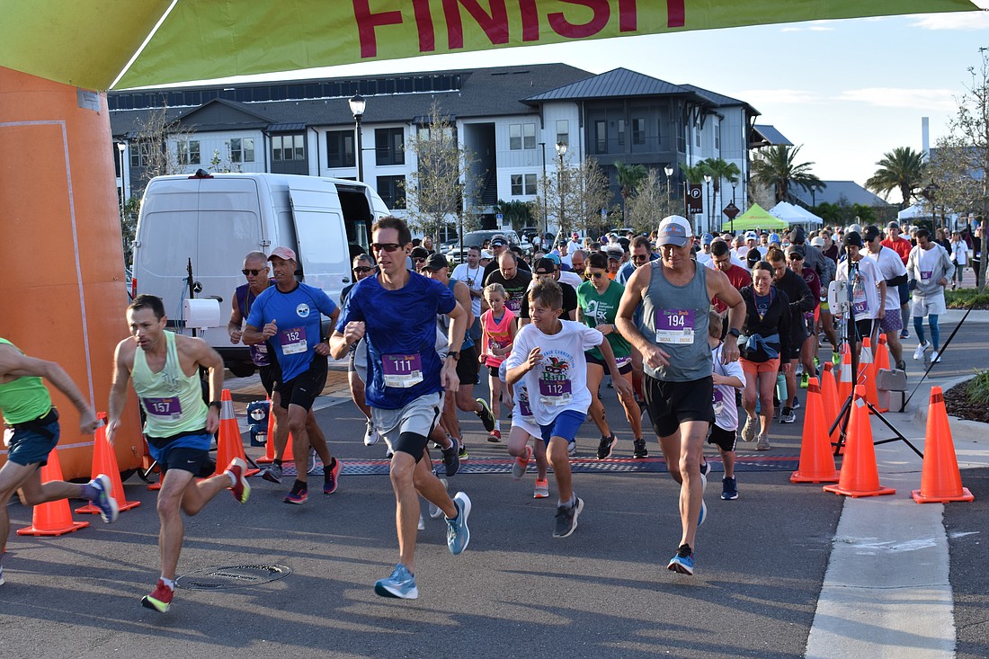 The runners sprint away at the start of the Run for the Beads 5K at Waterside Place. Funds for the race support area nonprofits through the Lakewood Ranch Community Fund.