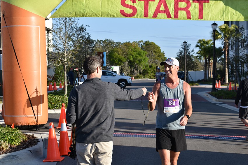 The Lake Club's David Ahrens earned his beads by finishing first in the 40-and-over men's division. Ahrens is 52.
