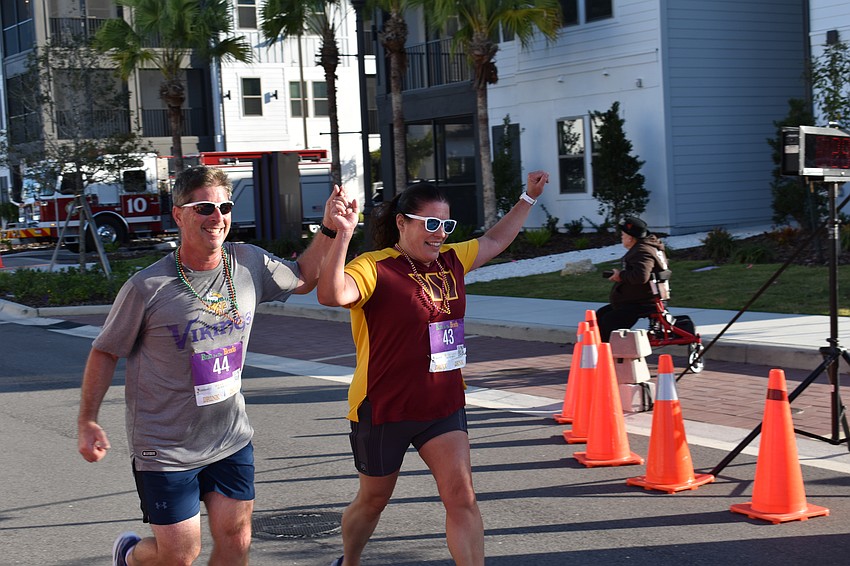 Lakewood Ranch's Laura and Steve Saladino triumphed together as they finish the Run for the Beads.