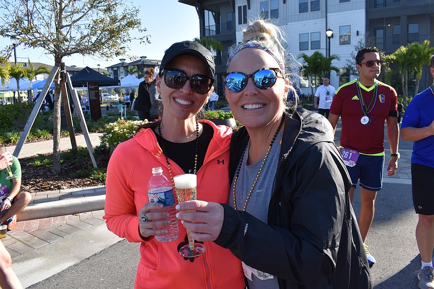 Celebrating meant water for Wynta Loughrey and a glass of champagne for Laura Loughrey after they finished the Run for the Beads.