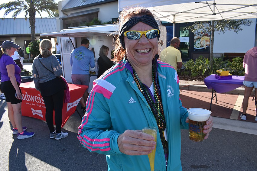 Monika Oberer enjoys a well-deserved adult beverage during the Run for the Beads after-party.