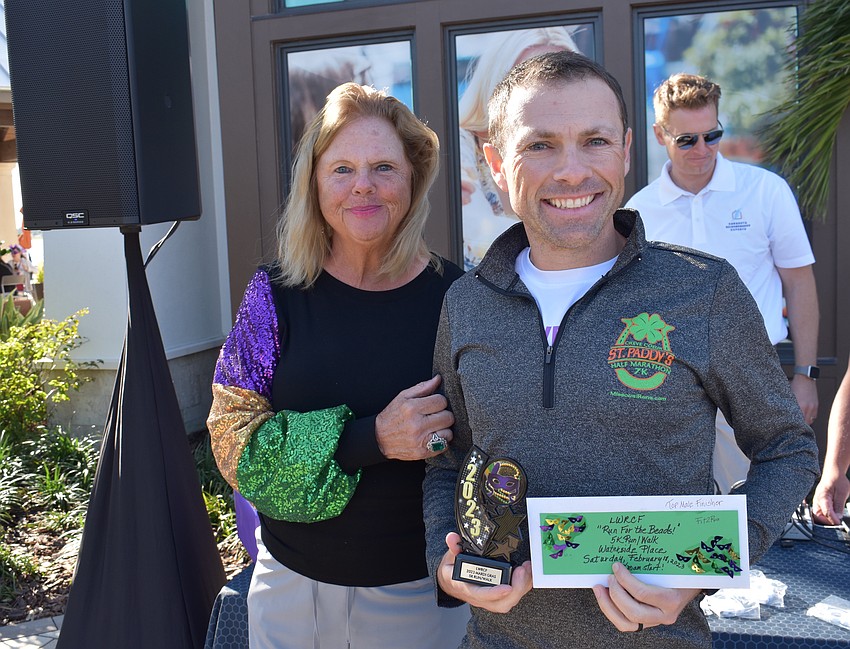 Annemarie Neubecker presents the championship medal to Lakewood Ranch's David Proudfoot.