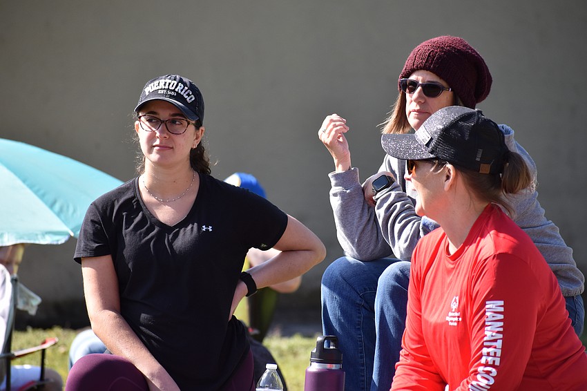 Lakewood Ranch's Allison Kramer and Laura Kramer, and Parrish's Heather D'Agostino enjoy the sun as they watch the competition.
