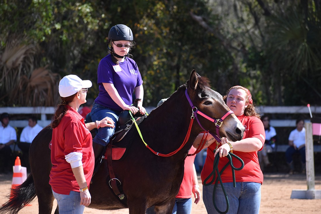Volunteer Melissa Newton accompanies Lakewood Ranch's 15-year-old Sophie Barry, as does volunteer Sarah Cripe.