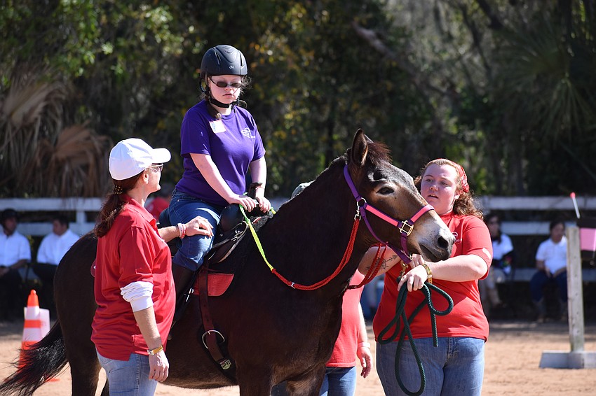Volunteer Melissa Newton accompanies Lakewood Ranch's 15-year-old Sophie Barry, as does volunteer Sarah Cripe.