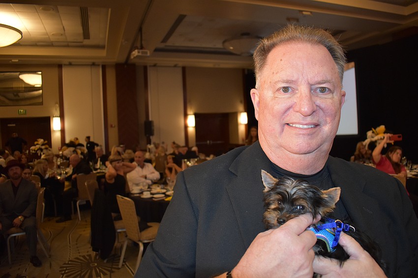 Lakewood Ranch's John Fain shows off the pup up for auction.