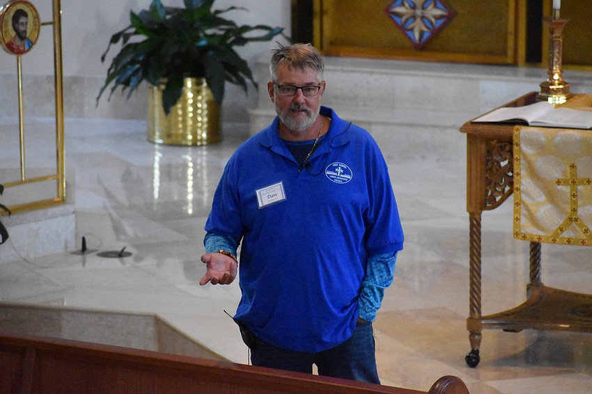 Dave Troyer offers a church tour to visitors.
