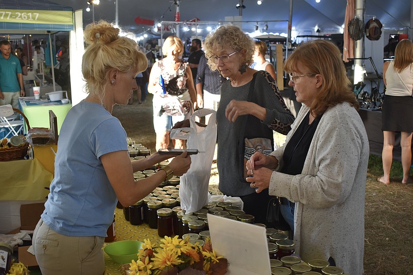 Tyeann Dillon and Ann Sullivan purchase from Vicky Nifora of Niko's Bees.