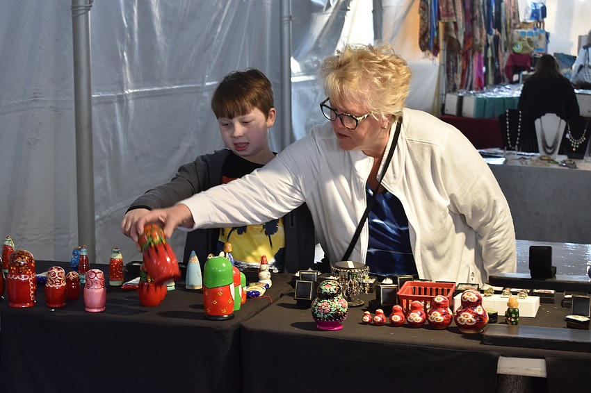 10-year-old Griffin Medsker from Illinois, and his grandmother, University Park's Heidi Fernis, browse the market items.
