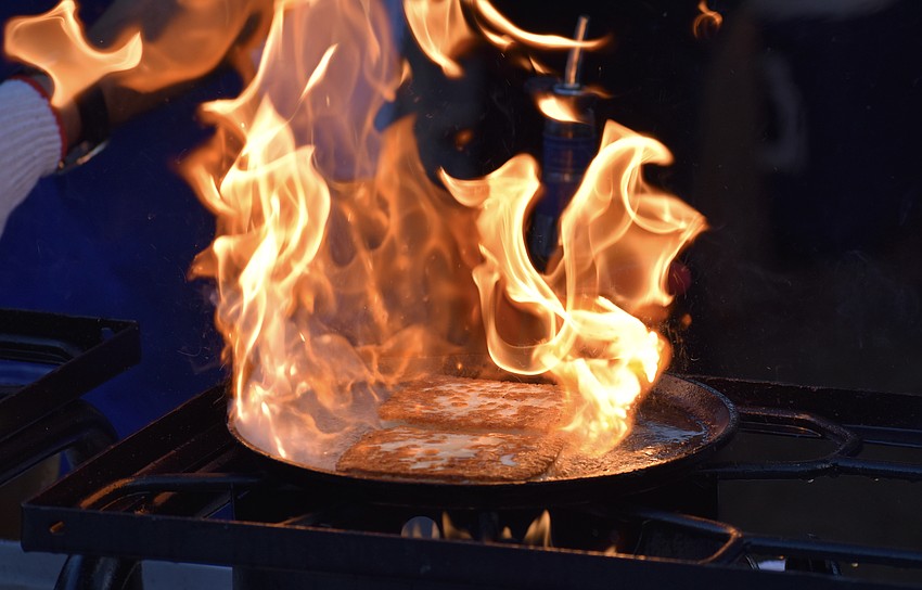 Flambeed, or flaming, cheese crisps within the fire.