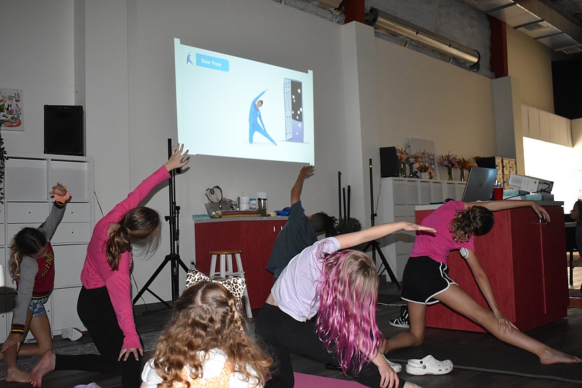 Cat University students get the wiggles out with some yoga.