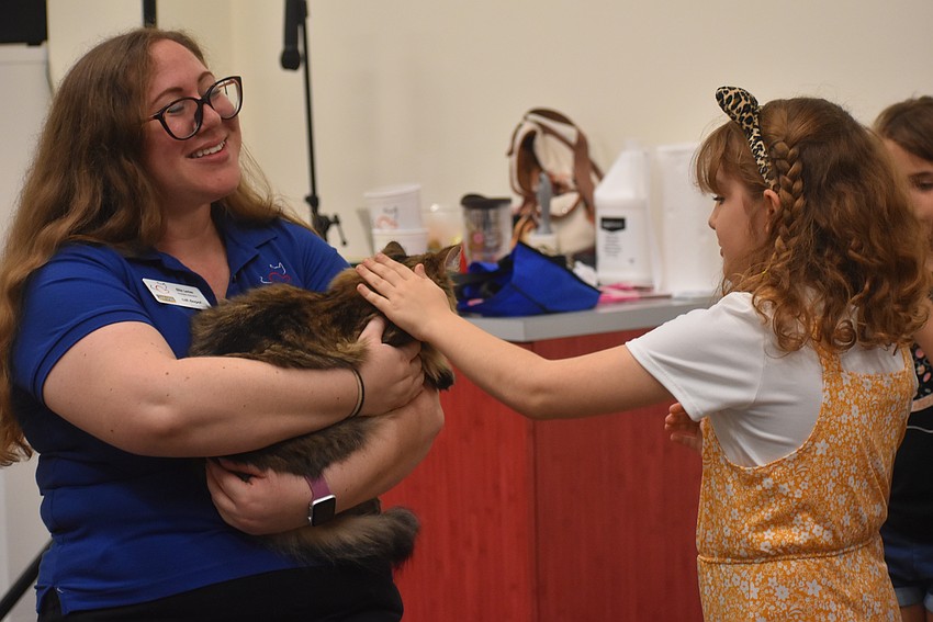 Cat Depot Humane Educator Ellie Levine brings Winney to kids to be petted.