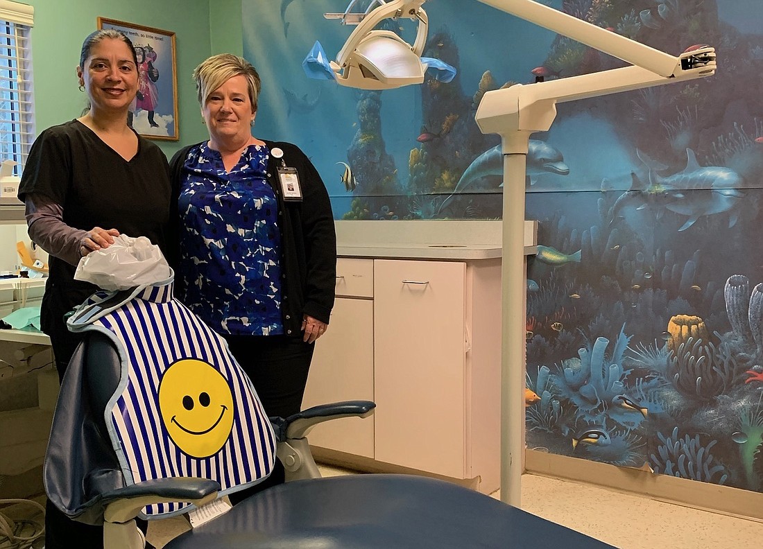 Flagler Health Department dentist Dr. Frances Bey and Dental Clinic Operations Manager Lisa Sanchez. The clinic tries to put a healthy smile on children's faces.