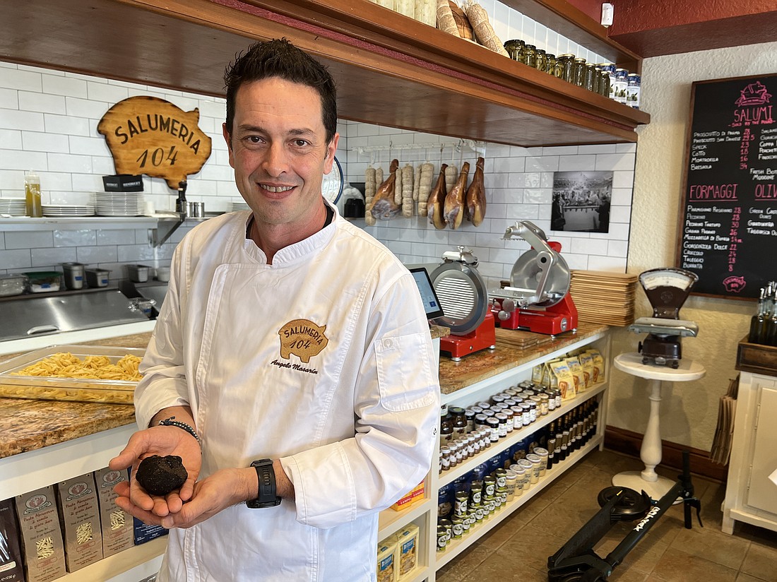 Angelo Masarin, Salumeria 104’s co-owner and corporate chef, holds an imported truffle from Italy worth almost $100.