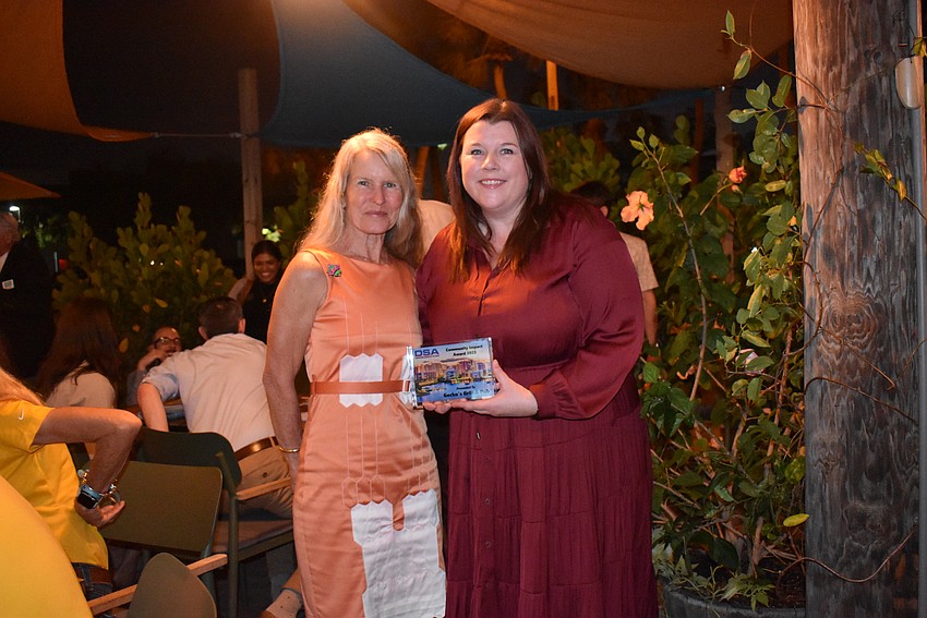 Anne Rollings and Fiona Farrell of Gecko's Hospitality Group take the Community Impact Award.