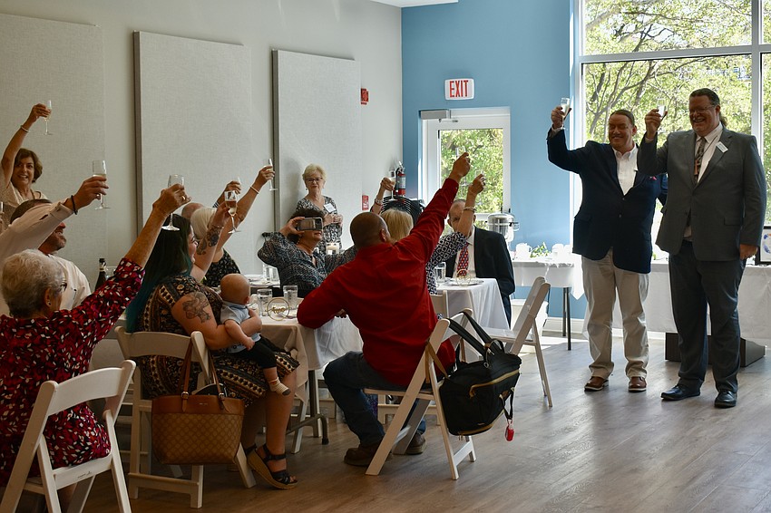 Michael and Jeffrey Nunes stand as the room toasts to Jeffrey's new role at the chapel.