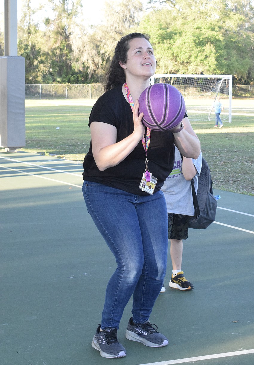 Stephanie Tretolo, a fourth grade teacher, tries her best in a basketball challenge.