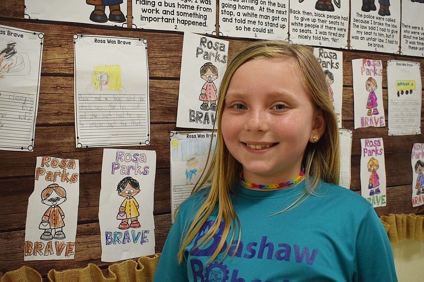 Mila Jorgensen, a first grader, shares her assignment on Rosa Parks.