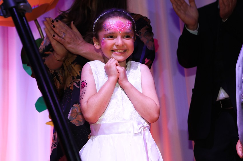 Make A Wish child Jocelyn Alvis takes in the applause.