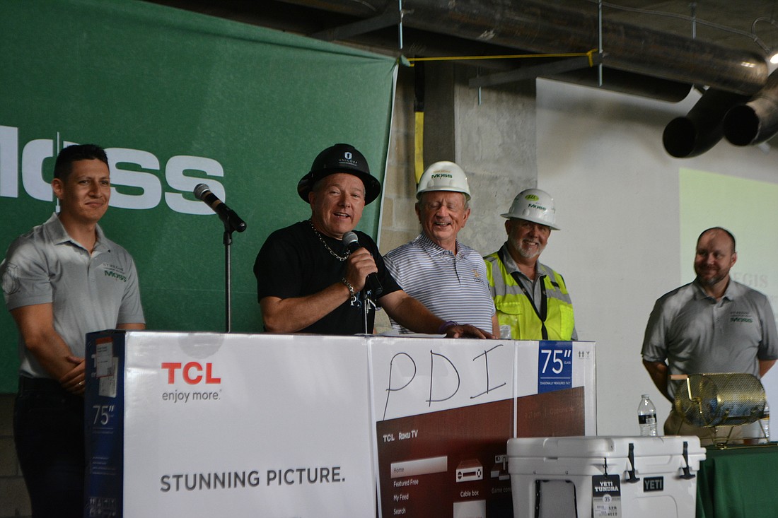 Andres Evans, Unicorps CEO Chuck Whittall, Bob Moss, Mike Ogorek and Josh Mutchler speak to attendees at Friday's topping-off.