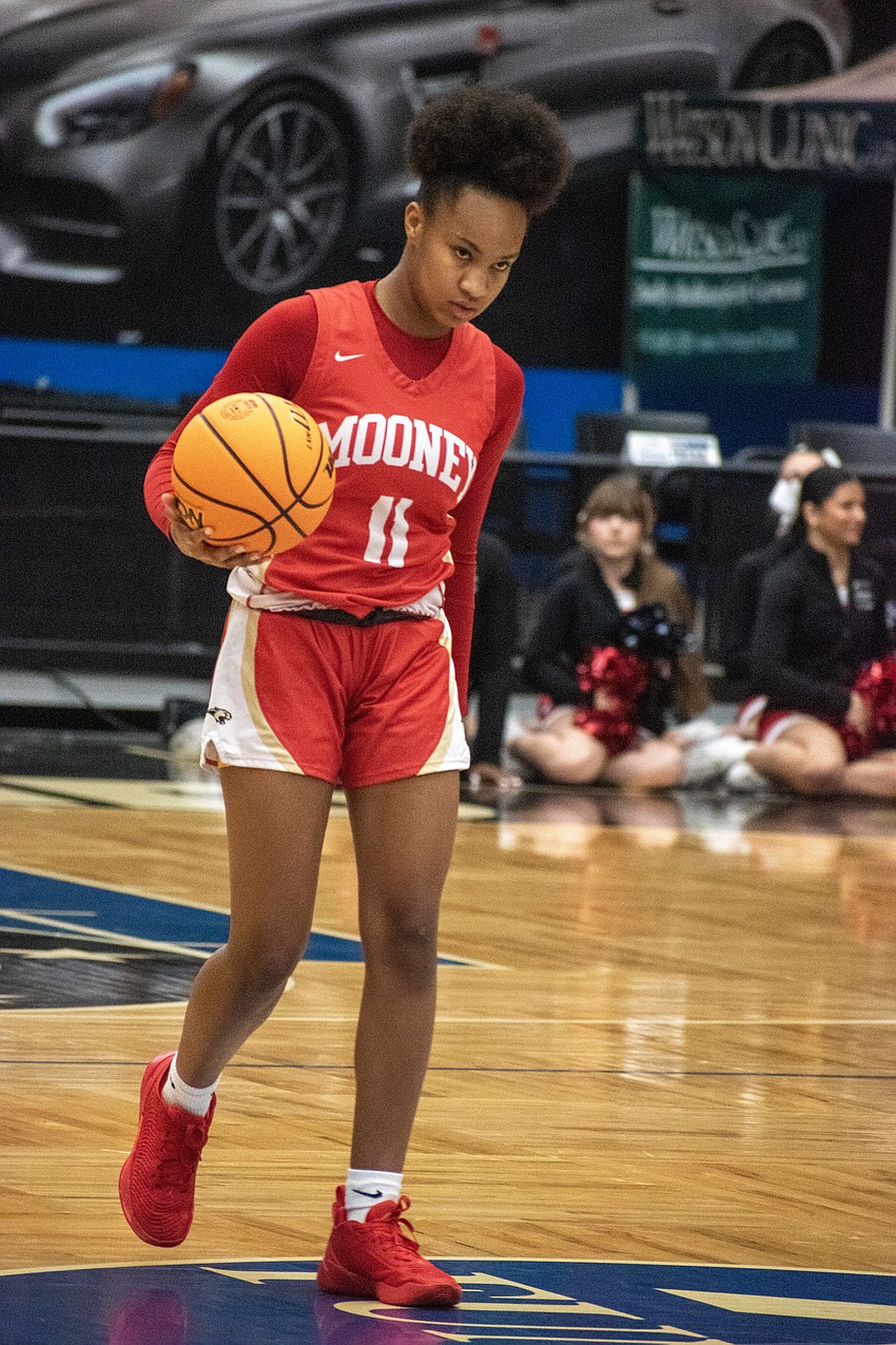 Mooney sophomore guard Bri Behn brings the ball up the court.