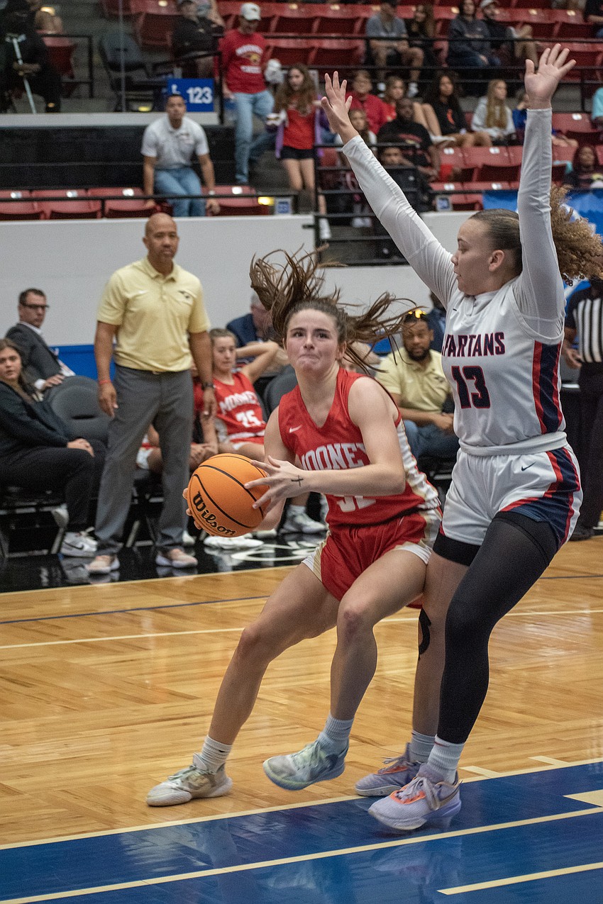 Mooney junior Sam Kotasek drives to the basket against Miami Country Day's Jalynn Belton.