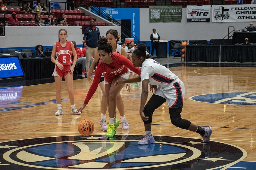 Mooney sophomore Kali Barrett cuts through a double-team attempt.