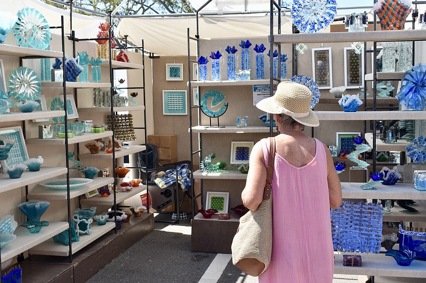 Shoppers browse art in various mediums.