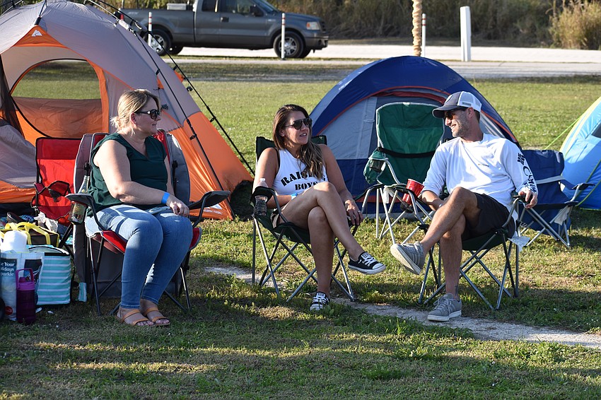Harmony's Melissa McDermott and her neighbors Danielle Caiano and Andy Caiano do a little kicking back at the Community Campout.