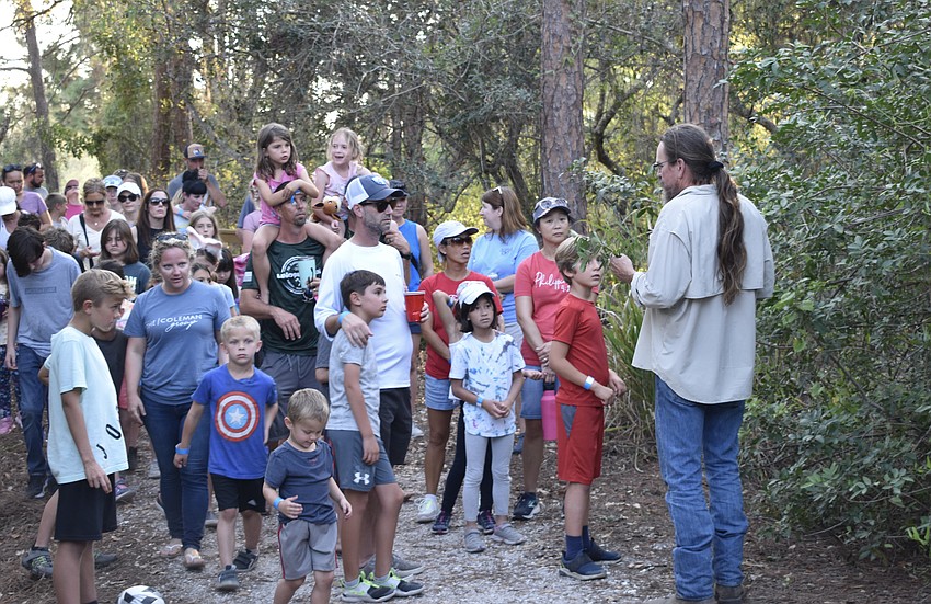 Bradenton's Joe Presley, right, leads the group on a nature walk during the Community Campout.
