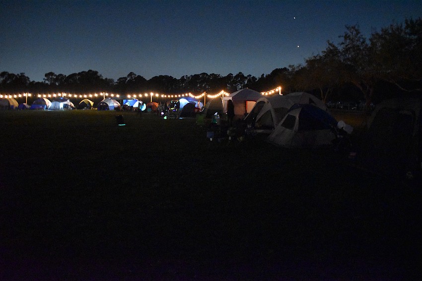 Darkness falls over the makeshift campsite.