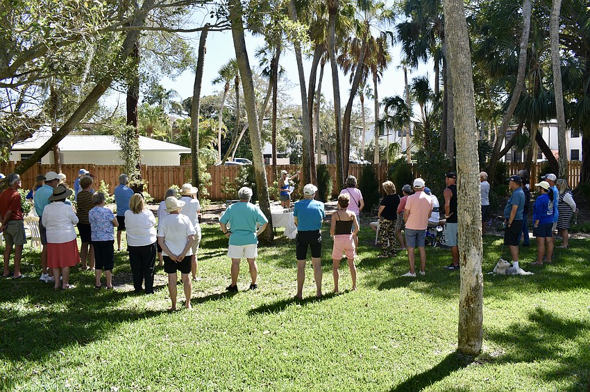 About 30 people gathered around to 