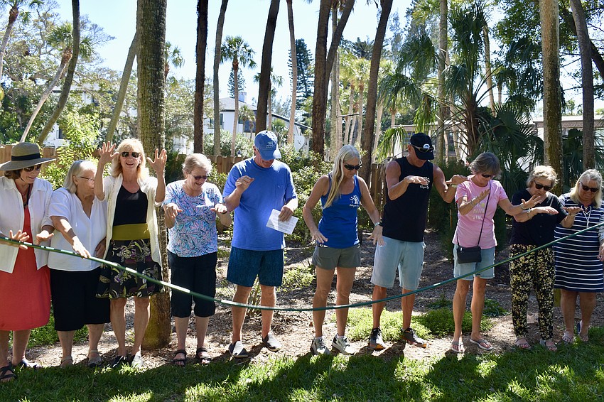 The hose gets dropped to celebrate Banyan Bay's new landscaping project.