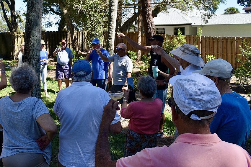 Community members celebrate with champagne.
