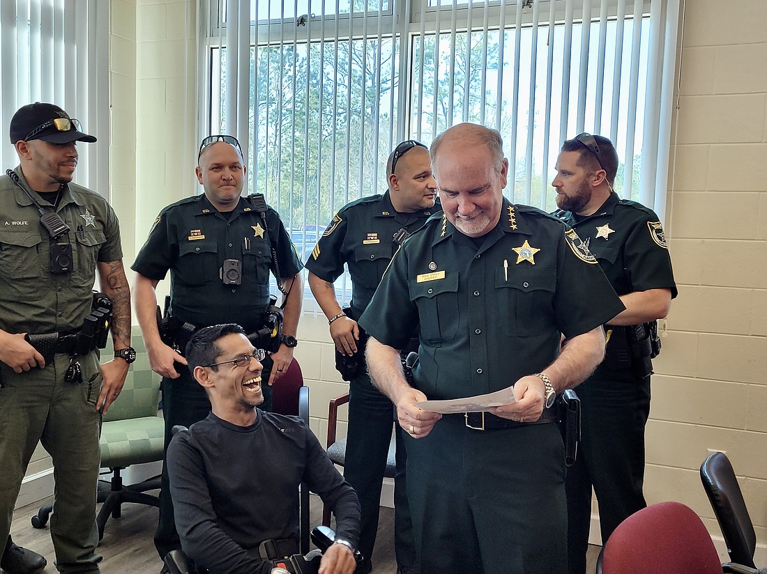 Manny Confusione shares a joke with Sheriff Rick Staly. Confusione won the Florida Animal Control Association's Volunteer of the Year award. Photo by Sierra Williams