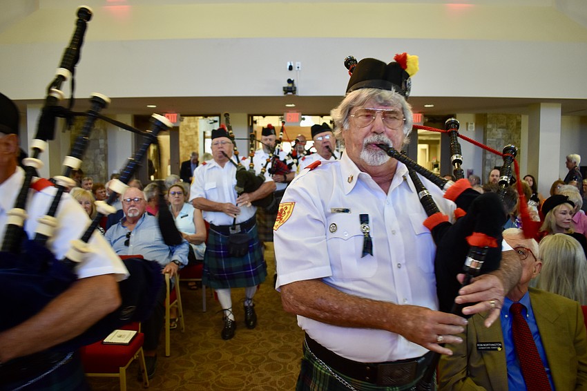 Bob Fair blows his bagpipe to celebrate the Kirkin' o the Tartans.