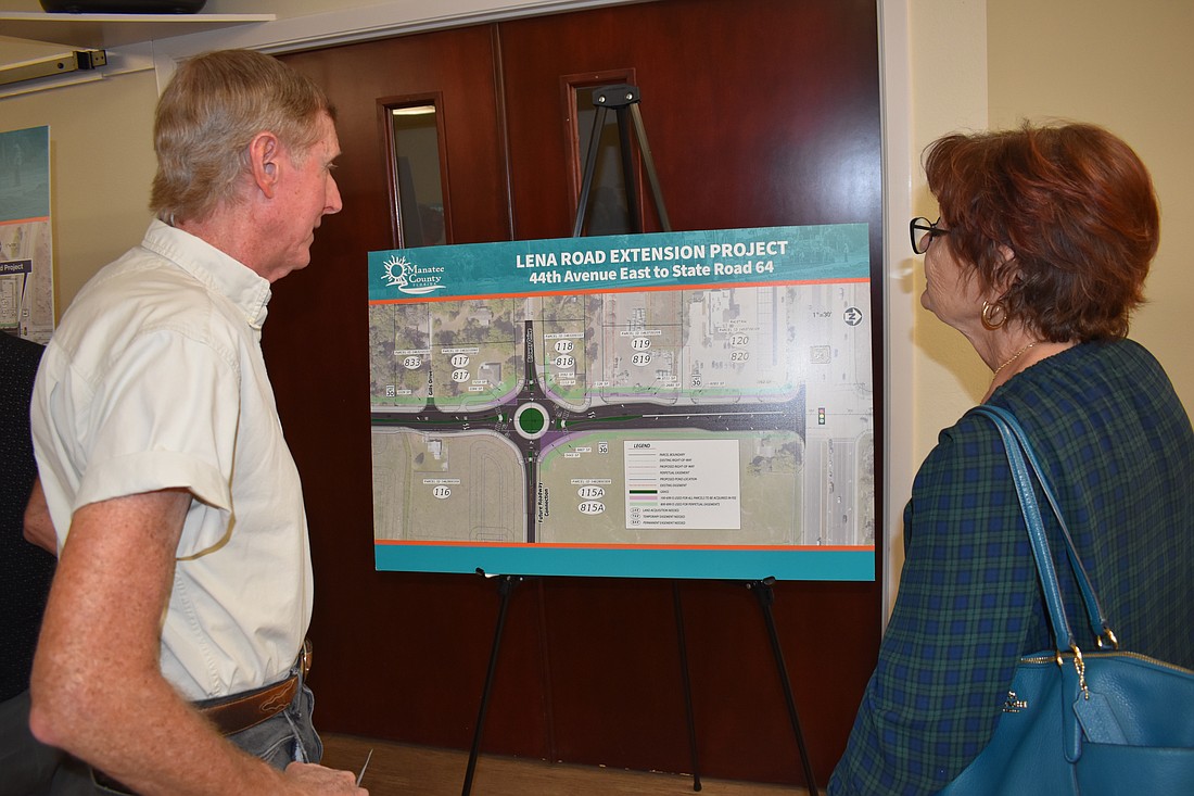 Mike Ferguson and Kim Ettel, two residents who have property bordering Lena Road, check out future plans for the road at a public meeting hosted by Manatee County at Peace Presbyterian Church.