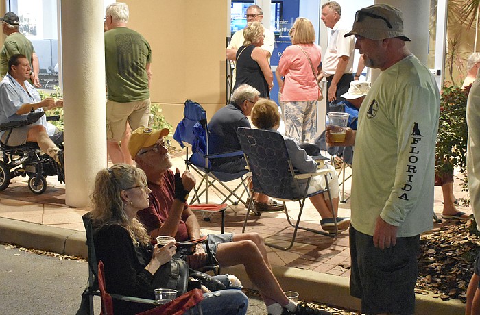 Lakewood Ranch's Beth Wood, her father John James from Ohio, and her husband Brian Wood, pick out a good spot on the street before the band begins.