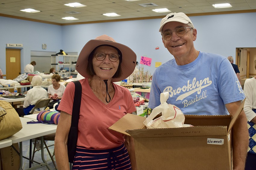Janet Masiello and Sal Lauro snag some Williams-Sonoma plates for a dollar a piece.