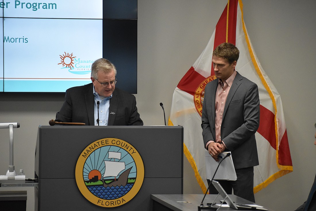 Deputy Director of Utilities Kevin Morris and Utilities Director Evan Pilachowski offer a presentation to commissioners on Jan. 17.