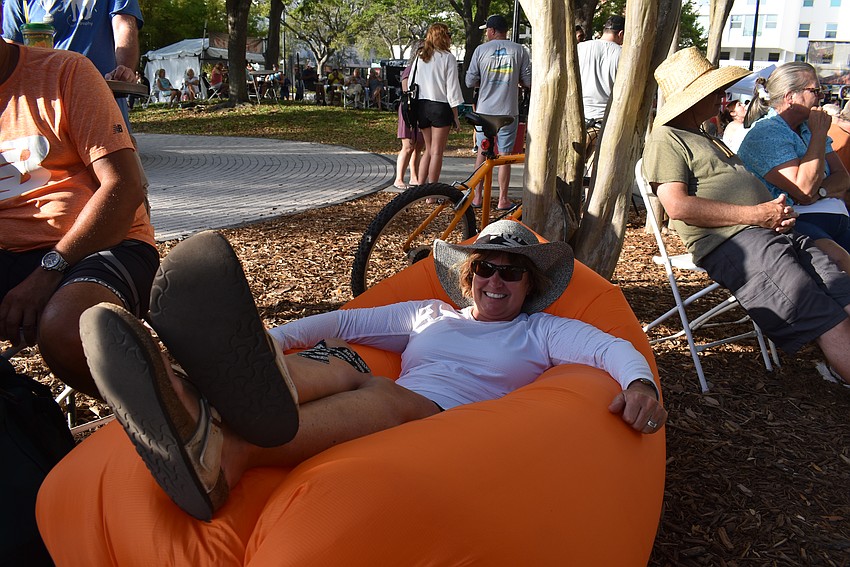 Nicole Guy lounges in her inflatable bed and listens to Blues at Downtown Sarasota Blues Festival.