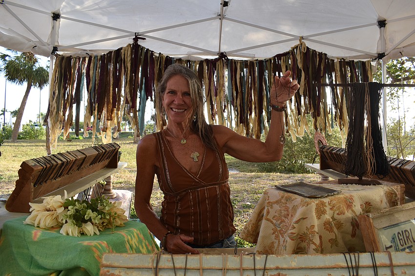 Linda Wagner sets up her booth at Downtown Sarasota Blues Festival.
