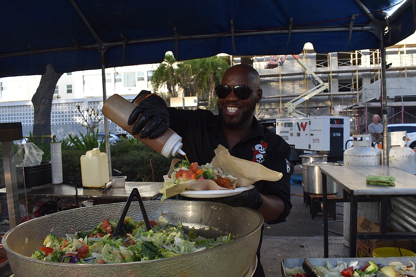 Othell Dunbar serves up grub for sttendees in between band changes.