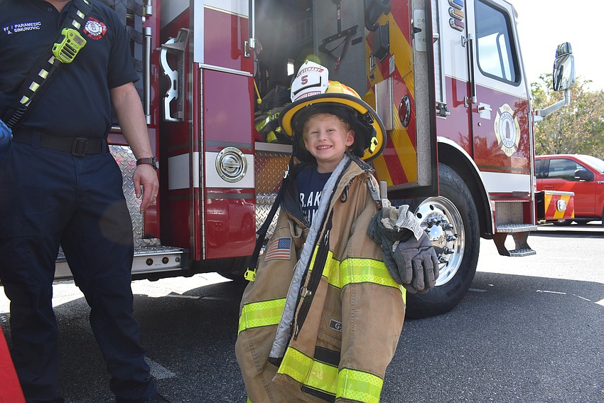 Blake Levine dress as a firefighter and meets local Sarasota firefighter Allen Simunovic at Temple Emanu-El Purim Carnival.